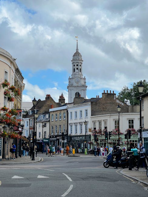 A vibrant street scene in Kingston upon Thames featuring a bouquet arrangement of fresh flowers held by a person in front of a shop. The bouquet includes a variety of blooms such as roses, tulips, and